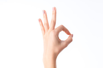 female hand showing the gesture with two fingers clasped and raised three  up isolated on white background