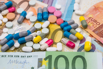 different pills and drugs on euro bills. close up.