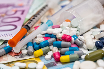 pills  with syringe above euro bills. Medicine cost.