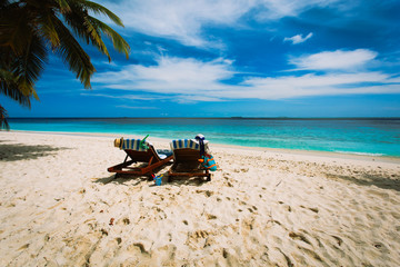 Fototapeta na wymiar family chairs on the tropical beach
