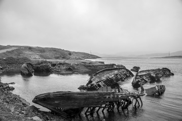 Cemetery of fishing boats in water of the Barents Sea, Teriberka