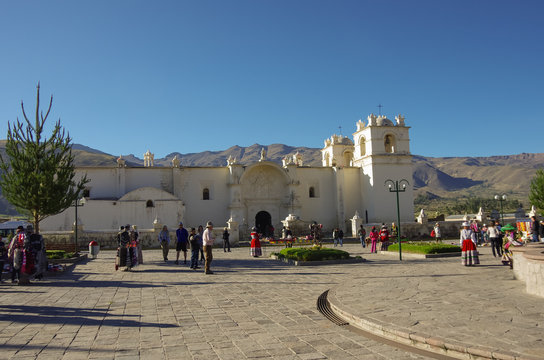 Main square and Church of the Immaculate Conception with mountains behind in Yanque, Colca Canyon, Peru. 