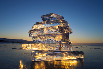 Pyramid of transparent pieces of ice on the surface of the lake Baikal