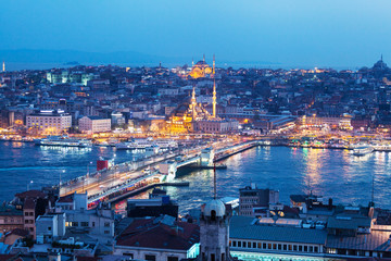 Obraz premium Panoramic views of the Bosphorus and the old part of Istanbul with lots of mosques illuminated at night. Aerial view
