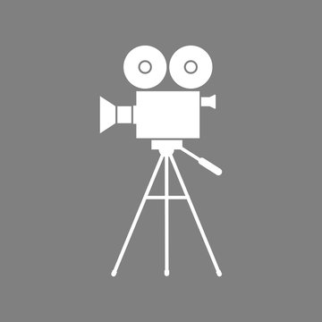 White movie camera vector icon on grey background