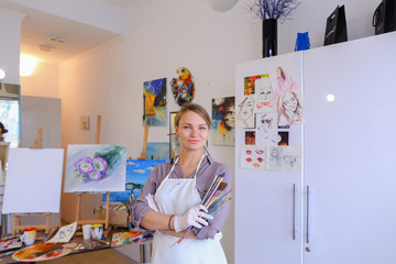 Women beautiful painter posing and smiling, laughing into camera
