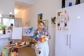 Women beautiful painter posing and smiling, laughing into camera