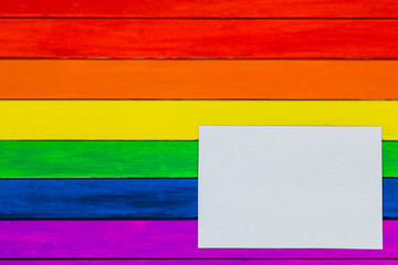 Trims in rainbow colors. Colorful wooden background. gay flag.