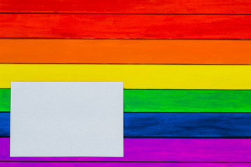 Trims in rainbow colors. Colorful wooden background. gay flag.