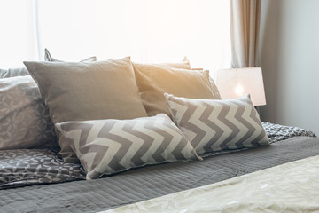 Fototapeta na wymiar set of pillows on bed in cozy bedroom
