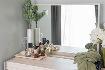 Beauty and make-up concept: table mirror, flowers, perfume, jewe