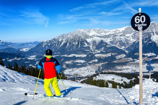 Skier skiing downhill in high mountains Wilder Kaiser