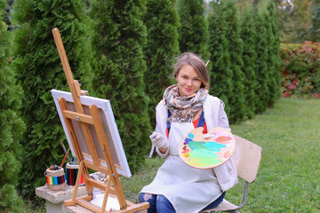 Women beautiful painter posing and smiling, laughing into camera