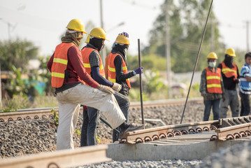 Construction team work in standard construction safety uniform installation rail way in mega project