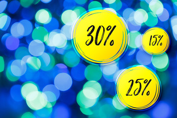 Blurred lights blue background. Sale discounts circles. Glittering christmas effect. Shimmering blur spots. Festive design.