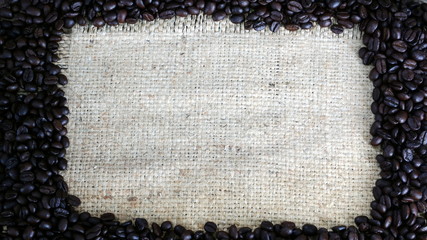 Dark roasting coffee beans on a wood table.
