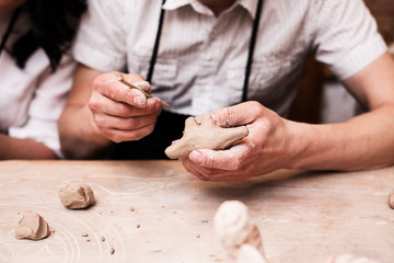 hands working with clay