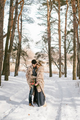 Fototapeta premium Outdoor happy couple in love posing in cold winter weather. Young boy and girl having fun outdoor