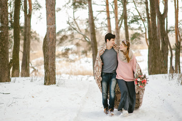 Fototapeta na wymiar Outdoor happy couple in love posing in cold winter weather. Young boy and girl having fun outdoor