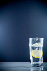 slice of lemon drops in a glass of water