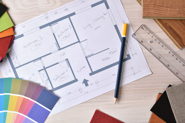Decorator workbench with home plan on wooden table top