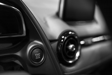 Obraz na płótnie Canvas Car dashboard with focus on engine start stop button