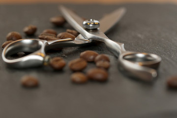 Professional hairdresser's scisors and coffe beans on the stone