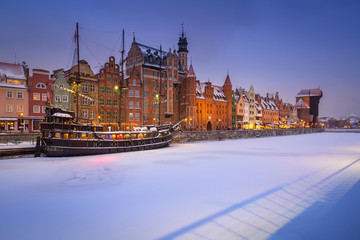 Fototapeta premium Old town of Gdansk at Motlawa river in snowy winter, Poland