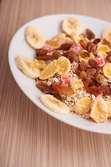 flakes with dried fruit, granola on the plate