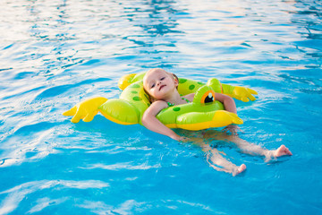 Cute little girl relaxing in swimming pool