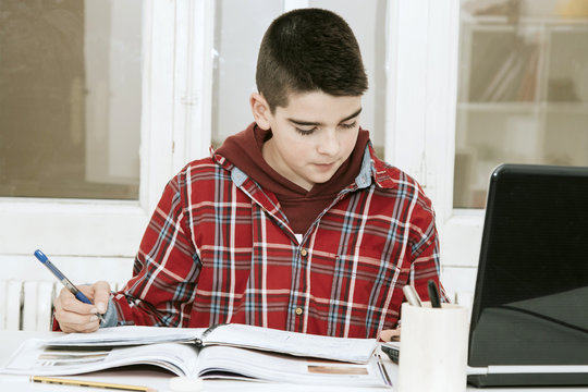 child studying in the desk of House or the school