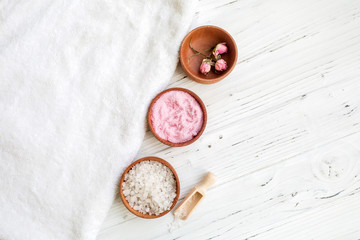 White and pink sea salt for spa on white wooden table