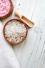 White and pink sea salt for spa on white wooden table