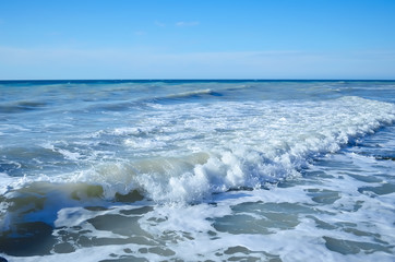 Waves rolled on the rocky coast
