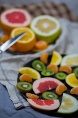 sliced pieces of citrus fruits are black two big plates of halves, blue gray, brown cloth rag towel