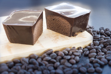 Cake shop, chocolate and coffee beans on a dark background.
