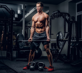 Fototapeta premium A man doing workouts in a gym.