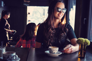 Smiling brunette woman in a cafe.