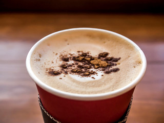 Coffee milk in paper cup on the table
