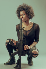 Black warrior woman with assault rifle,  portrait