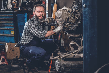 Fototapeta na wymiar A man repairing the car's engine.