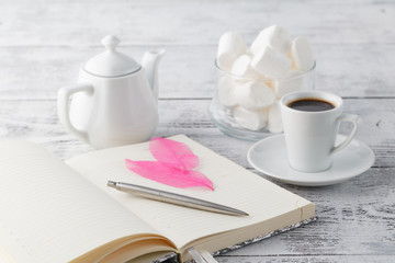 Coffee in white porcelain cup on wooden table