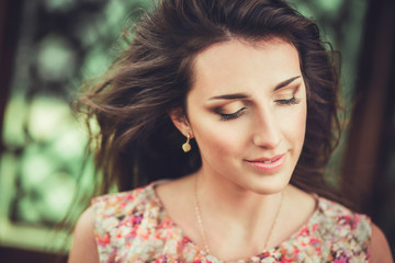 Naklejka premium Happy beautiful young woman in spring blossom park. Pretty Girl with Spring Flowers. Fashion Model Outdoors