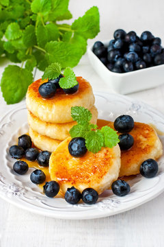Cheese pancakes with syrup and blueberry