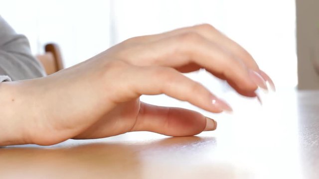 Young Woman taps her fingers on the table