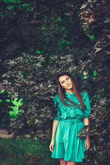 Happy beautiful young woman in spring blossom park. Pretty Girl with Spring Flowers. Fashion Model Outdoors