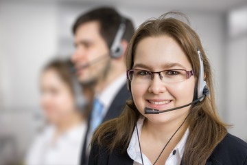 Telemarketing and customer service concept. Young smiling woman - operator in call center.