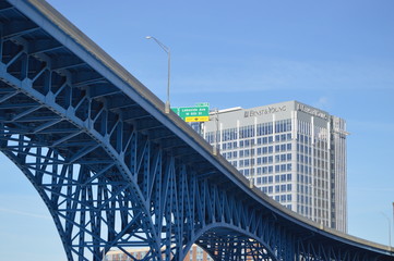 Bridge with corporate building and freeway sign in the background.