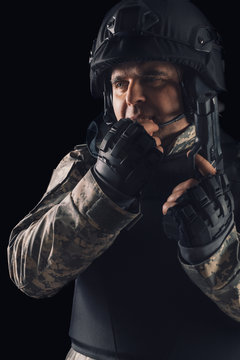 Special forces soldier with gun on dark background