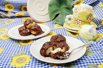 Chocolate profiteroles filled with cream